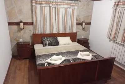 a bedroom with a bed with two pillows on it at Семейна къща Лазарови in Sapareva Banya