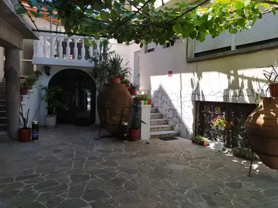 a courtyard with potted plants in front of a building at Каламанди in Asenovgrad