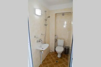 a bathroom with a toilet and a sink at Villa Rila Garden in Beli Iskar