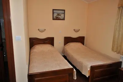 a room with two beds in a room at Spartak Family Hotel in Smolyan