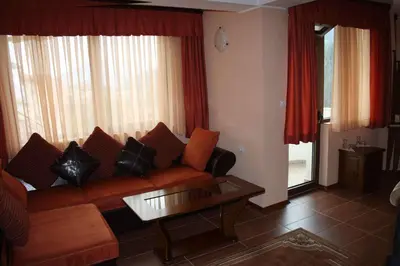 a living room with a couch and a table at Spartak Family Hotel in Smolyan