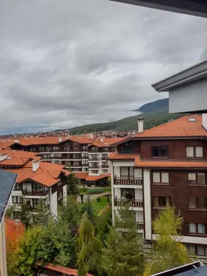 a group of apartment buildings in a city at Apartment BanskoIN in Bansko