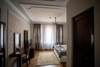 a hotel room with a bed and a window at BULGARI melnik in Melnik