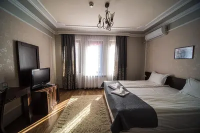 a hotel room with a bed and a television at BULGARI melnik in Melnik