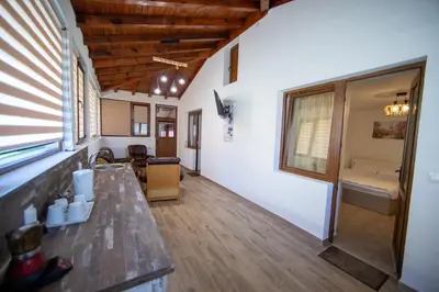 a room with a wooden floor and a table at Къща за гости детелина - лина in Sapareva Banya