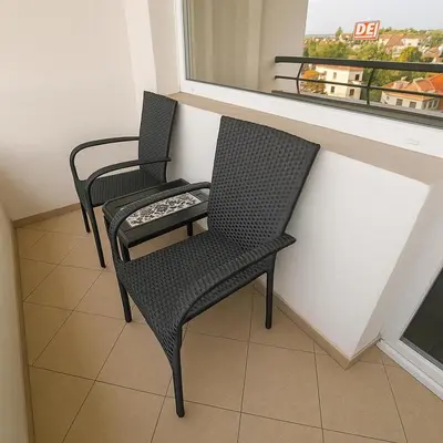two chairs sitting next to a window in a room at North Panoramic Apartment in the art district of Kapana in Plovdiv
