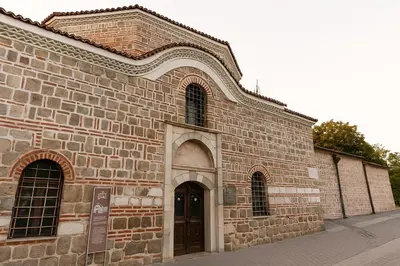 a large brick building with a door on a street at North Panoramic Apartment in the art district of Kapana in Plovdiv