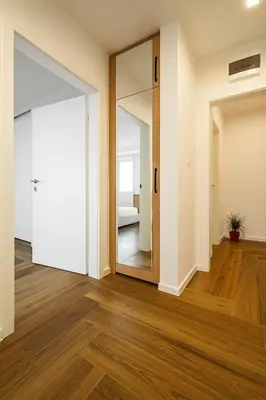 an empty room with a door and a mirror at North Panoramic Apartment in the art district of Kapana in Plovdiv