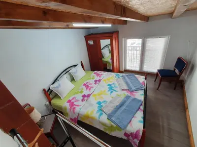 a bedroom with a bed with books on it at Modern and Old LODGE in Sofia