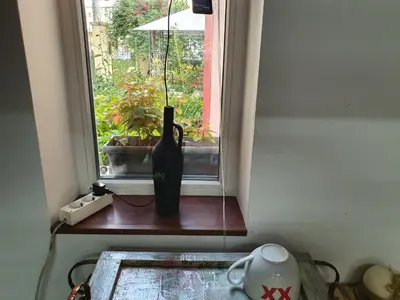 a vase sitting on a window sill in front of a window at Modern and Old LODGE in Sofia