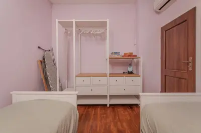a bedroom with two beds and a dresser and a door at 2BD Flamingo Flat with Balcony in Sofia Center by Flat Mаnager in Sofia