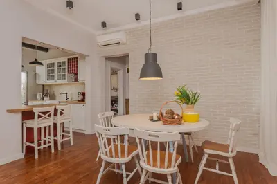 a kitchen and dining room with a table and chairs at 2BD Flamingo Flat with Balcony in Sofia Center by Flat Mаnager in Sofia