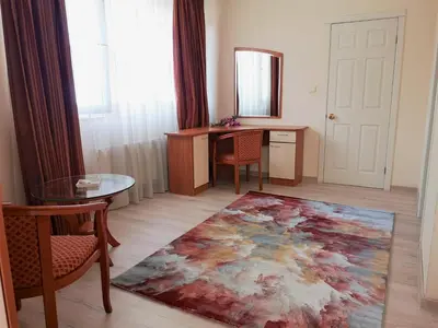 a living room with a table and a rug at Sofia hotel apartments in Sofia
