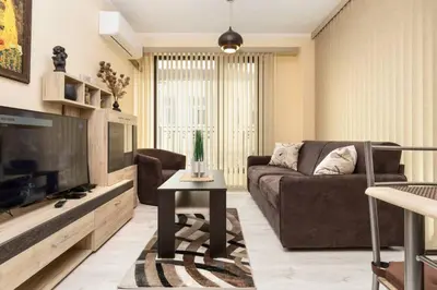 a living room with a couch and a tv at Cozy new Apartment 'Casa Vacanza ' ✵ TOP CENTER ✵ in Plovdiv