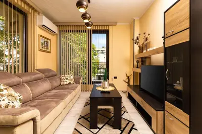 a living room with a couch and a tv at Cozy new Apartment 'Casa Vacanza ' ✵ TOP CENTER ✵ in Plovdiv