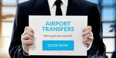 a man in a suit holding a sign that reads airport transfers at Top Center Detached Apartment Studio in Sofia