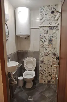 a bathroom with a toilet and a sink at Top Center Detached Apartment Studio in Sofia