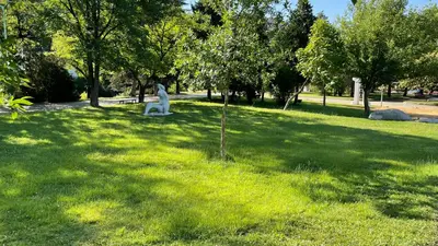 a statue of a dog sitting in a park at Thea Apart in Sandanski