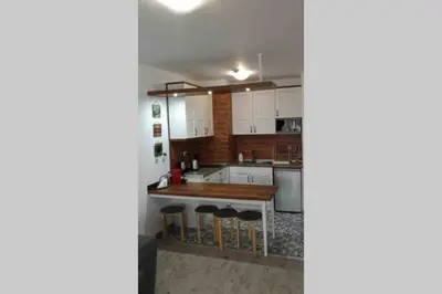 a kitchen with white cabinets and a counter top at Belvedere Holiday Club VIP Apartment H 82 in Bansko