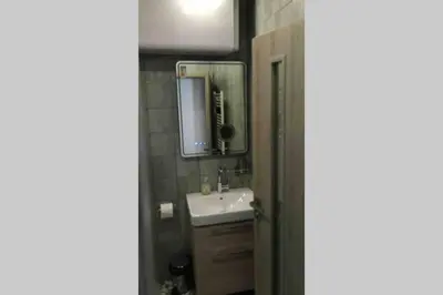 a bathroom with a sink and a mirror at Belvedere Holiday Club VIP Apartment H 82 in Bansko