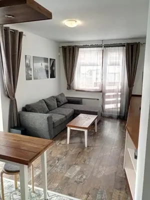 a living room with a couch and a table at Belvedere Holiday Club VIP Apartment H 82 in Bansko