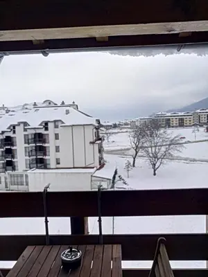 a view of a snow covered field from a balcony at Belvedere Holiday Club VIP Apartment H 82 in Bansko