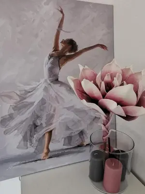 a painting of a woman dancing next to a pink flower at Brand New Apartment in Sofia