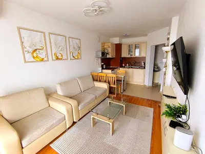 a living room with a couch and a table at Belvedere Holiday Club Private Apartment in Bansko