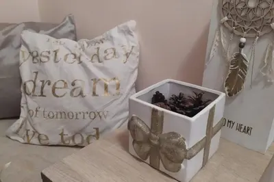 a box of dried flowers on a table with a pillow at Lovely City Center 1BD, 1BT Apartment in Sofia