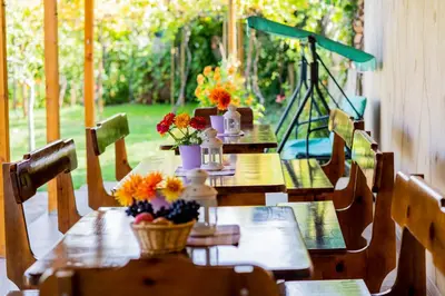 two tables with flowers on them on a patio at Къща Лиляна in Resilovo