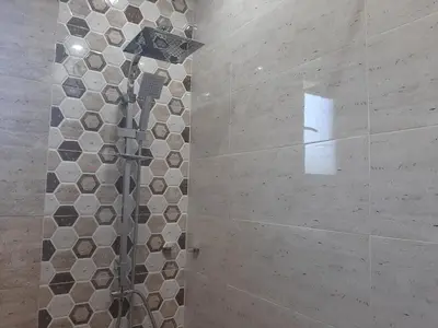a shower in a bathroom with a tile wall at Вила Мая 2 in Krayni Dol
