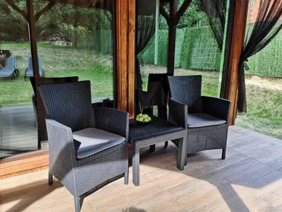 two chairs and a table on a patio at Вила Мая 2 in Krayni Dol