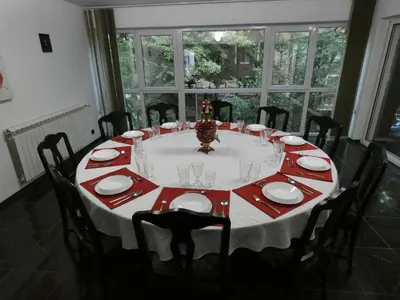 a dining room table with a red and white table cloth at Grande - Velingrad in Velingrad
