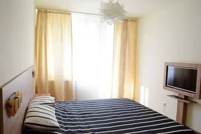 a bedroom with a bed and a tv and a window at Cozy One Bedroom Apartment in Iglika Complex in Borovets