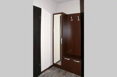 a closet with a wooden door and a mirror at Cozy One Bedroom Apartment in Iglika Complex in Borovets