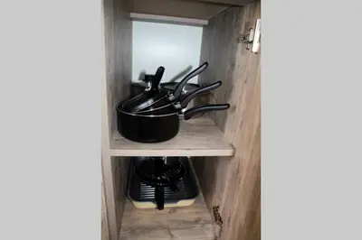 a kitchen cabinet with a pot on a shelf at Cozy One Bedroom Apartment in Iglika Complex in Borovets