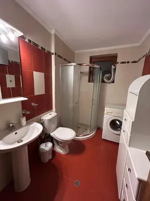 a bathroom with a toilet and a shower and a sink at Апартамент Планинско Гнездо - Mountain Nest in Stoykite