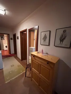 a room with a wooden cabinet and a room with a mirror at Апартамент Планинско Гнездо - Mountain Nest in Stoykite