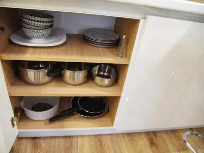 a cupboard with plates and pans and dishes at Borovets Gardens Luxury apartment E11 in Borovets