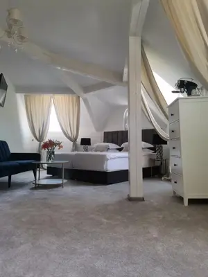 a bedroom with a bed and a couch and a table at Villa al Tempio in Pazardzhik