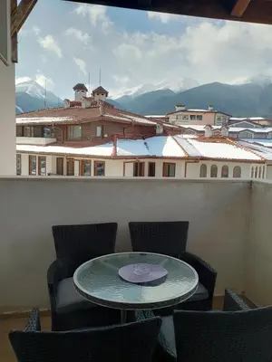 a table and chairs on a balcony with a view at Bansko Royal Towers - Studio 153 in Bansko