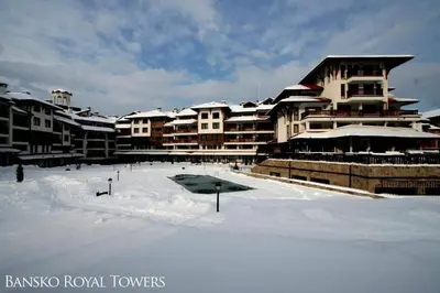 a snow covered parking lot in front of a large building at Bansko Royal Towers - Studio 153 in Bansko