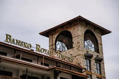 a brick building with a sign on top of it at Bansko Royal Towers - Studio 1237 in Bansko