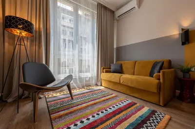 a living room with a couch and a chair and a rug at Top Center 2 Aptartments - Gurko Str in Sofia