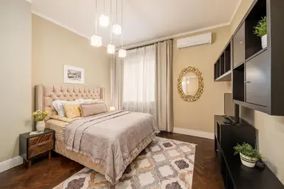 a bedroom with a large bed and a mirror at Top Center 2 Aptartments - Gurko Str in Sofia