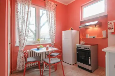 a small kitchen with a table and a refrigerator at Top Center 2 Aptartments - Gurko Str in Sofia