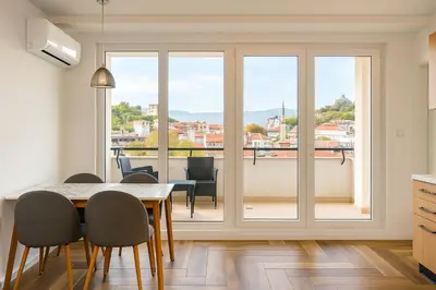 a kitchen and dining room with a table and chairs at South Panoramic Apartment in the art district of Kapana in Plovdiv