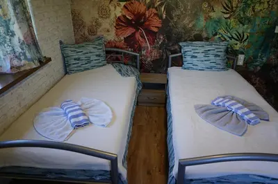 two beds with towels on them in a room at Старата къща / село Тъжа in Tŭzha