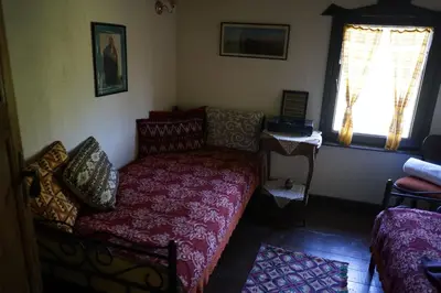 a living room with a couch and a window at Старата къща / село Тъжа in Tŭzha