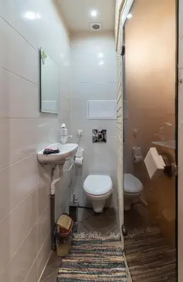 a bathroom with a sink and a toilet and a mirror at Ковачева-3 in Bansko